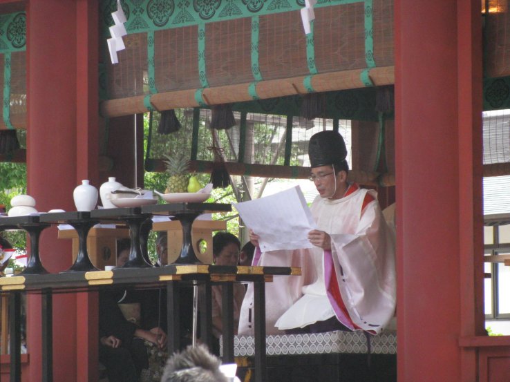 Shinto priests wear black caps as a symbol of enlightenment
