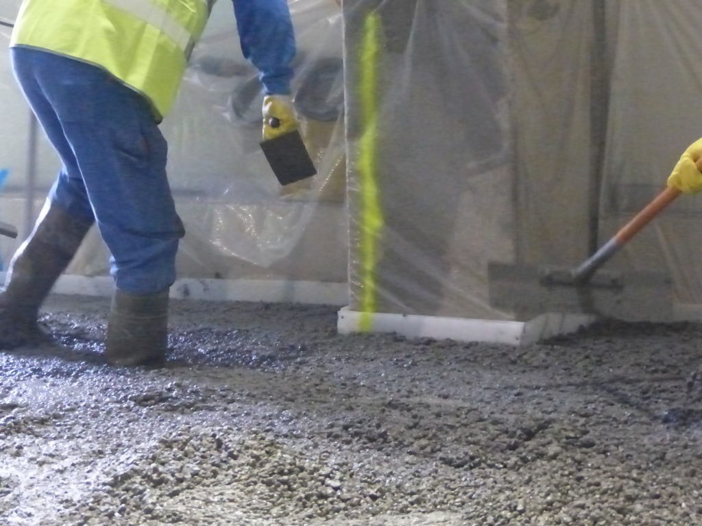 man installing concrete floor