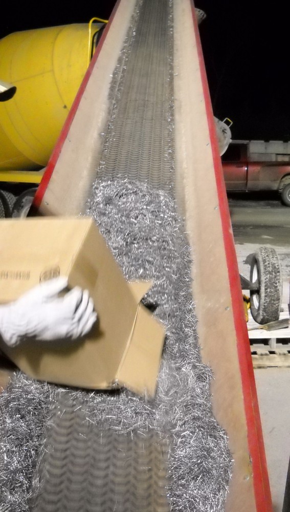 Steel fibers are being loaded into a ready-mix truck. Fibers are usually added at the concrete plant, but can also be added onsite. [CREDIT] Photo courtesy Mike McPhee 